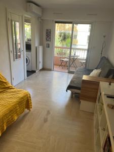 a bedroom with a bed and a living room with a view at Condo in a private residence with pool in Nice
