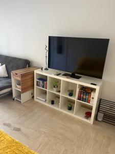 a white entertainment center with a flat screen tv at Condo in a private residence with pool in Nice