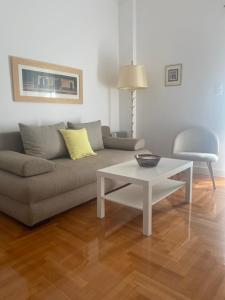 a living room with a couch and a coffee table at Neapoli Modern Apartment in Athens