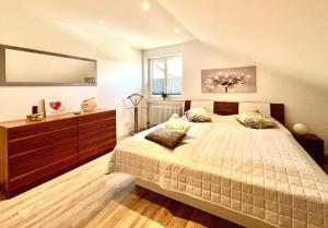 a bedroom with a large bed and a large mirror at Ferienwohnung Klosterblick in Öhningen +25 photos