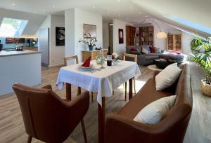a kitchen and living room with a table and chairs at Ferienwohnung Klosterblick in Öhningen