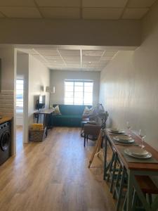 a living room with a table and a couch at Pistachio - Paarl - Self Catering Apartment in Paarl