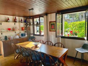 a dining room with a wooden table and chairs at La Grande Villa with Pool in Lignano Sabbiadoro