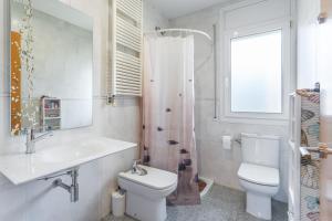 a bathroom with a toilet and a sink and a shower at Villa Sol in La Canyera +18 photos