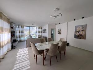 a dining room and living room with a table and chairs at Spacious 3-Bedroom Chalet and Maid Room in Fouka Bay in Marsa Matruh