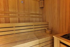 an empty wooden sauna with a bucket in it at Boutique hotel Ruzmarin SPA & Garden by Aycon in Budva