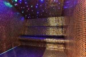 a room with purple and blue lights on a wall at Boutique hotel Ruzmarin SPA & Garden by Aycon in Budva