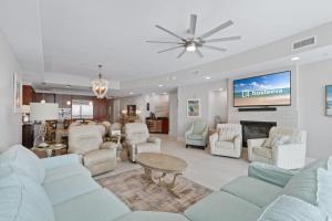 a living room with white furniture and a tv at Turquoise Place 1108 D in Orange Beach