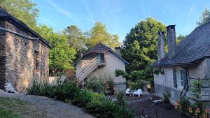 an old house with a garden in front of it at Domaine Le Mayne in Chabrignac