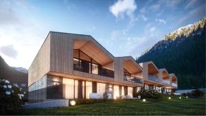 een huis in de bergen met de zon erop schijnend bij Panorama Chalets Pitz Alpin in Sankt Leonhard im Pitztal