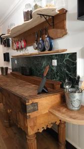 a kitchen with a wooden table with pots and pans at Domaine Le Mayne in Chabrignac +71 photos