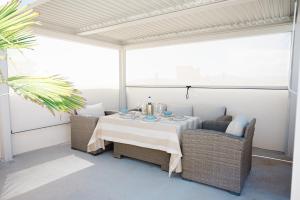 a dining table and chairs on a patio at Apartamento Casa Gallardo in Blanes