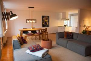 a living room with two couches and a table at WenneQuartier in Schmallenberg
