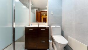a bathroom with a toilet and a sink and a mirror at Star Paradise in Armação de Pêra +27 photos