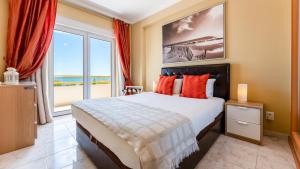 a bedroom with a large bed and a large window at Star Paradise in Armação de Pêra