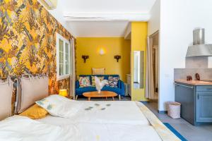 a bedroom with a bed and a yellow wall at Charmante Villa avec piscine in Fontvieille +25 photos