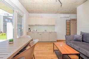 a living room with a table and a couch at Monciskes Terrace Apartment in Palanga