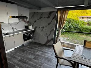 a kitchen with a counter and a table and a counter top at Beach house Chris in Pakoštane +6 photos