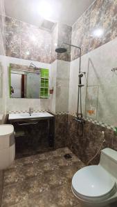 a bathroom with a toilet and a sink and a mirror at Studio luxury District 10 - A paradise of food, shopping and beauty take care services in Ho Chi Minh City +29 photos