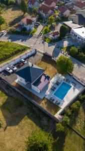 an aerial view of a house with a swimming pool at Villa Hanna Ilidža in Kamenjača