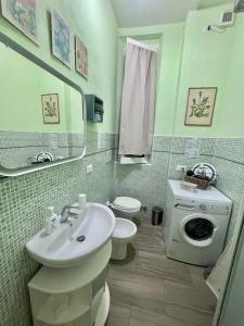 a bathroom with a sink and a toilet and a mirror at La Casa dei Fiori in La Spezia