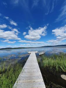 a wooden dock in the middle of a lake at Camp Caroli Hobbit Hut in Jukkasjärvi