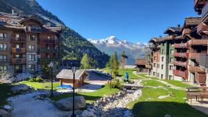 a group of buildings with mountains in the background at 812 Manoir Savoie in Bourg-Saint-Maurice
