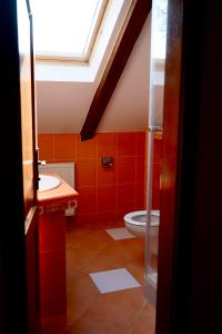 a bathroom with a toilet and a skylight at Ludwig - penzión&reštaurácia in Prešov