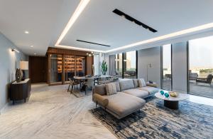 a living room with a couch and a table at Durrat Jalmouda Hotel in Al Jubail