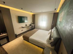 a hotel room with a bed and a television at HL 309 Hotel in Tashkent