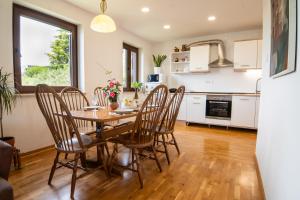 a kitchen and dining room with a table and chairs at Apartments Elza in Portorož +17 photos
