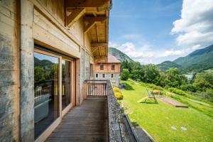 a wooden balcony with a view of a house at Les Gites Leyetaz in Châtillon-sur-Cluses