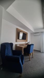 a living room with a blue couch and a desk at New Wolf in Bran