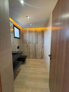 a bathroom with a wooden door in a room at La Demeure du Bonheur in Hammamet Sud +22 photos
