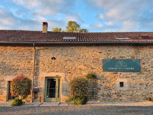 a stone building with a sign in front of it at Domaine de la Tardoire in Oradour-sur-Vayres