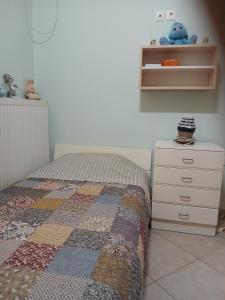 a bedroom with a bed and a dresser at Marry's Guesthouse in Kineta