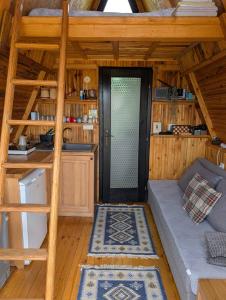 a room with a couch and a staircase in a cabin at A Pine vikendica u srcu Zapadne Srbije in Nova Varoš +37 photos