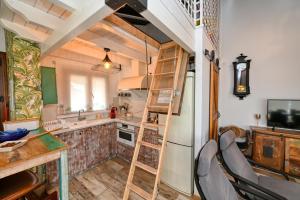 a kitchen with a ladder next to a refrigerator at Cortijo Los Matías in Sayalonga +5 photos