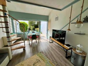 a living room with a table and a fireplace at Casa Otarie avec piscine et terrasse -Proxi plage, port, gare in Pornic
