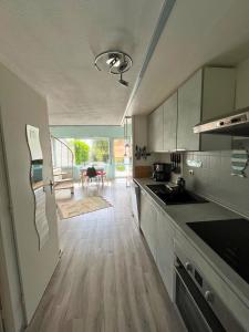 a kitchen with a sink and a counter top at Casa Otarie avec piscine et terrasse -Proxi plage, port, gare in Pornic