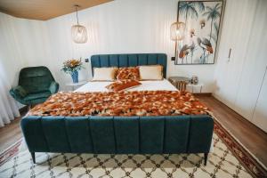 a bedroom with a large bed with a green headboard at Casa da Veiga de Ponte de Lima in Ponte de Lima
