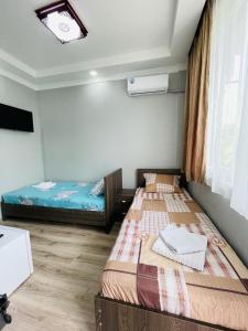 Postel nebo postele na pokoji v ubytování New Batumi