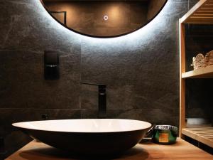 a large bowl sink in a bathroom with a mirror at Hygge Sauna&Spa in Gleźnowo +22 photos