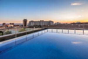 a large swimming pool on the roof of a building at Hotel Granada by Pierre & Vacances in Granada