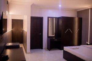 A bed or beds in a room at Skyrock Hotels Ogba