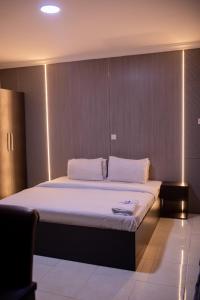 A bed or beds in a room at Skyrock Hotels Ogba