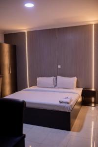 A bed or beds in a room at Skyrock Hotels Ogba