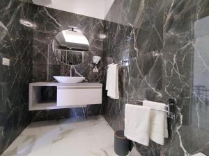 a bathroom with a sink and a mirror at B&B Ilary Tropea in Tropea +20 photos