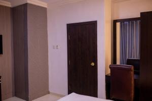 A bed or beds in a room at Skyrock Hotels Ogba