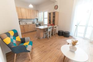 a kitchen and living room with a table and chairs at Skyard - Central 2bd House in Kos